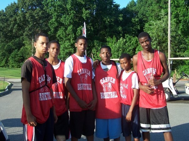 Young alumni basketball team in red uniforms