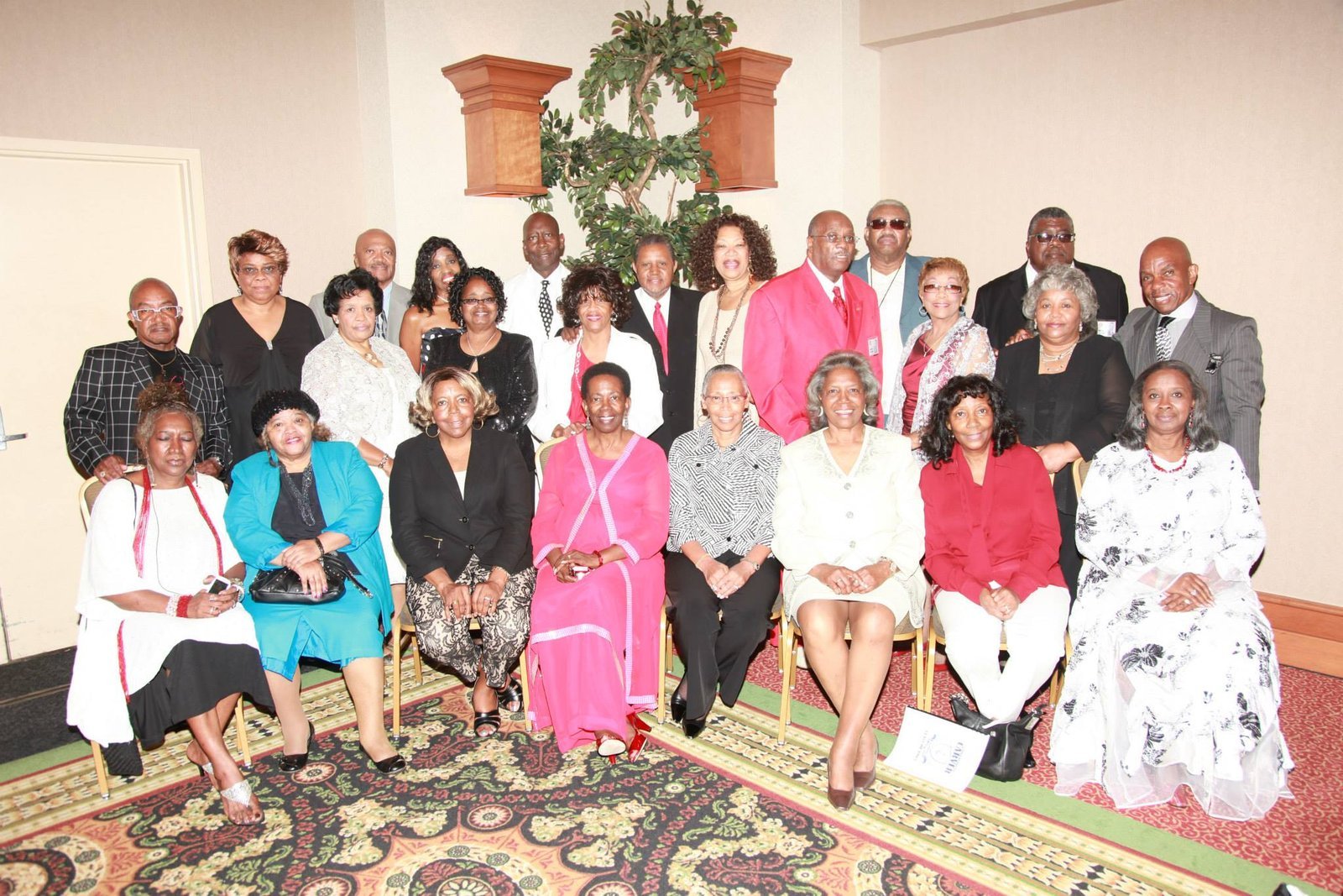 Large alumni group photo at formal event with elegant attire