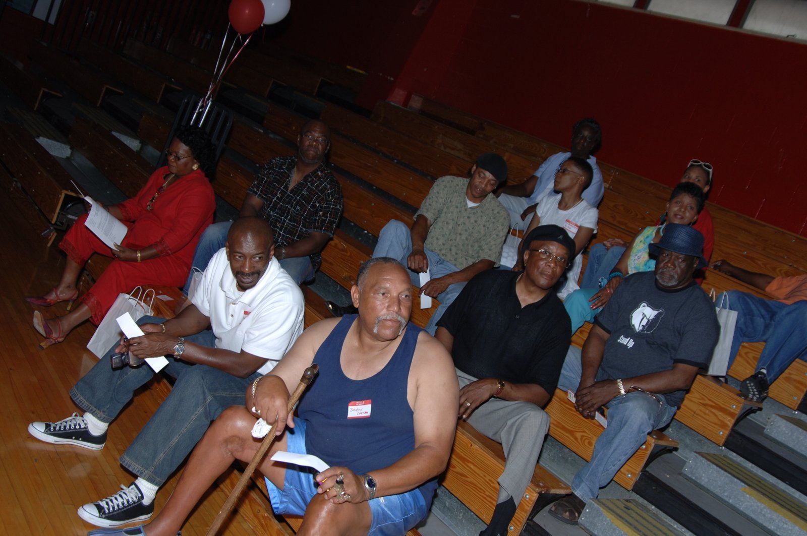 Alumni seated on bleachers at school event