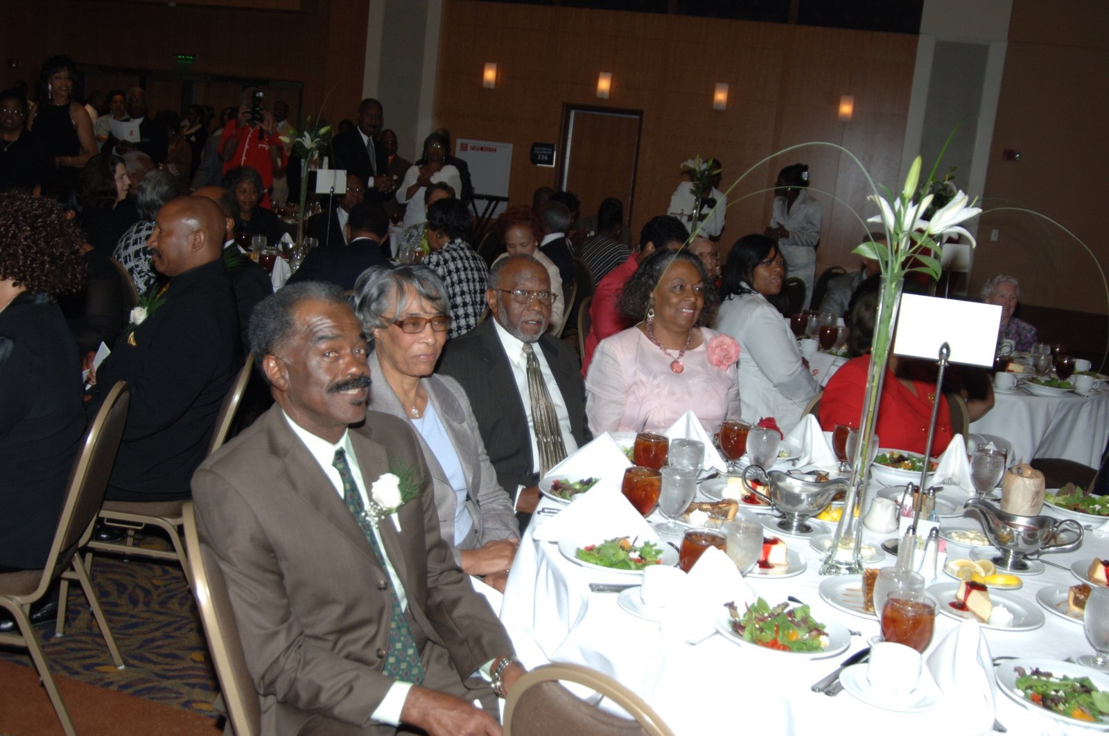 Alumni at formal event with flowers and table arrangements
