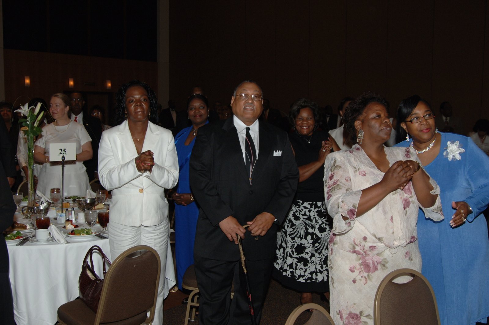 Alumni at formal event with flowers and table settings