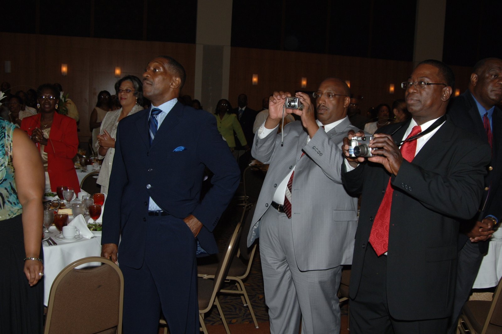Alumni at formal banquet event taking photos