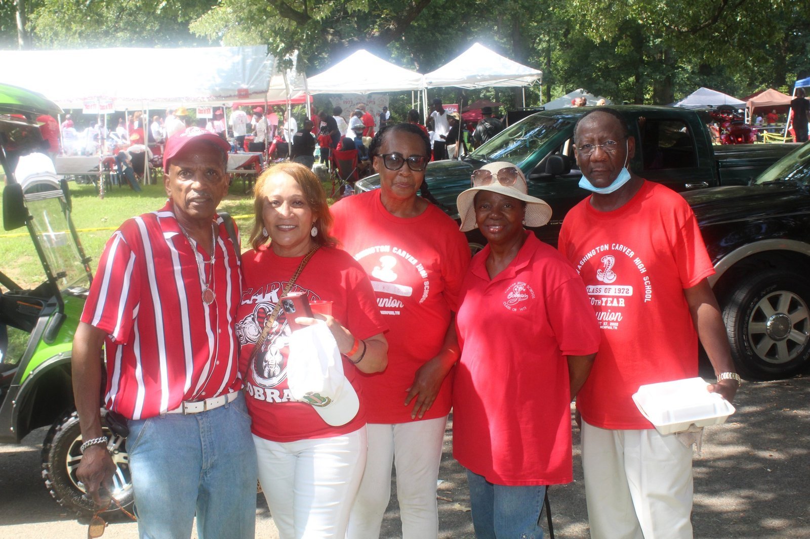 Alumni group at outdoor event in red attire