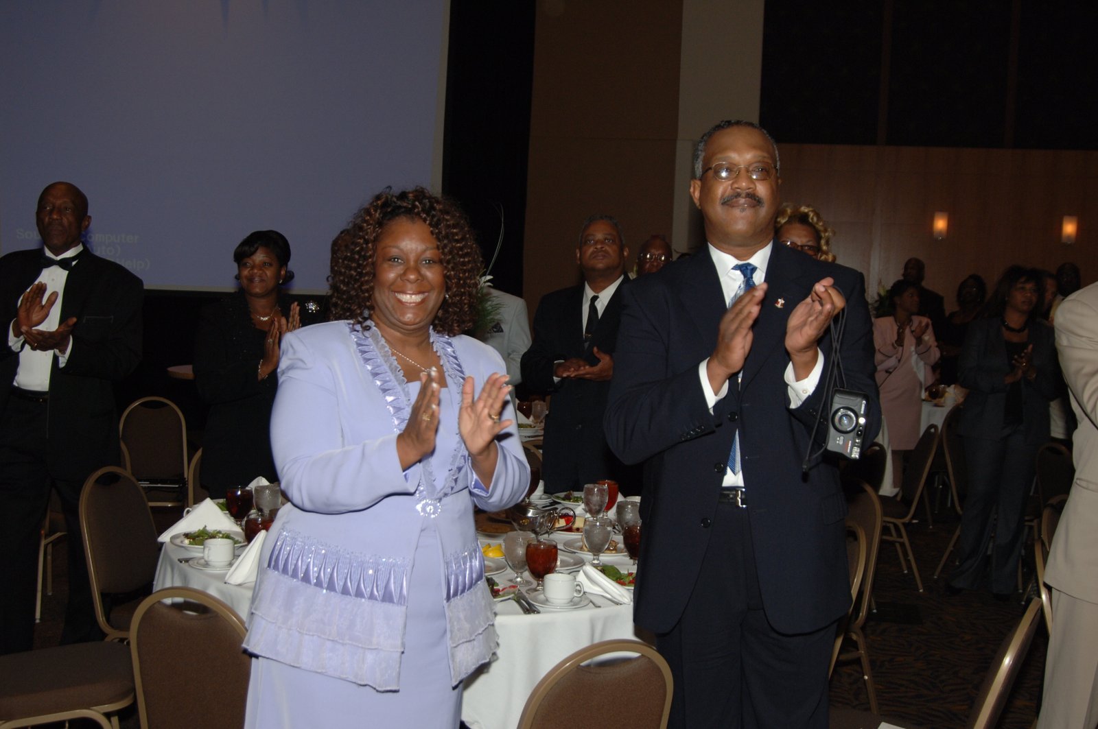 Alumni at formal banquet event applauding