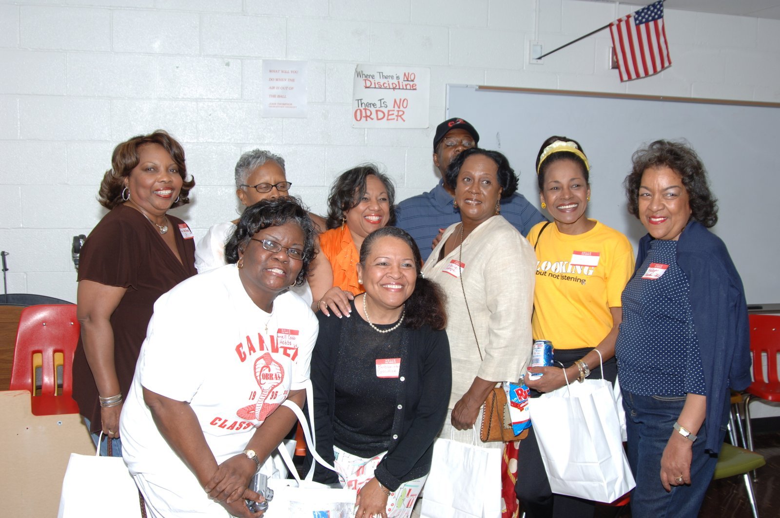 Alumni group photo at school event with red and white theme
