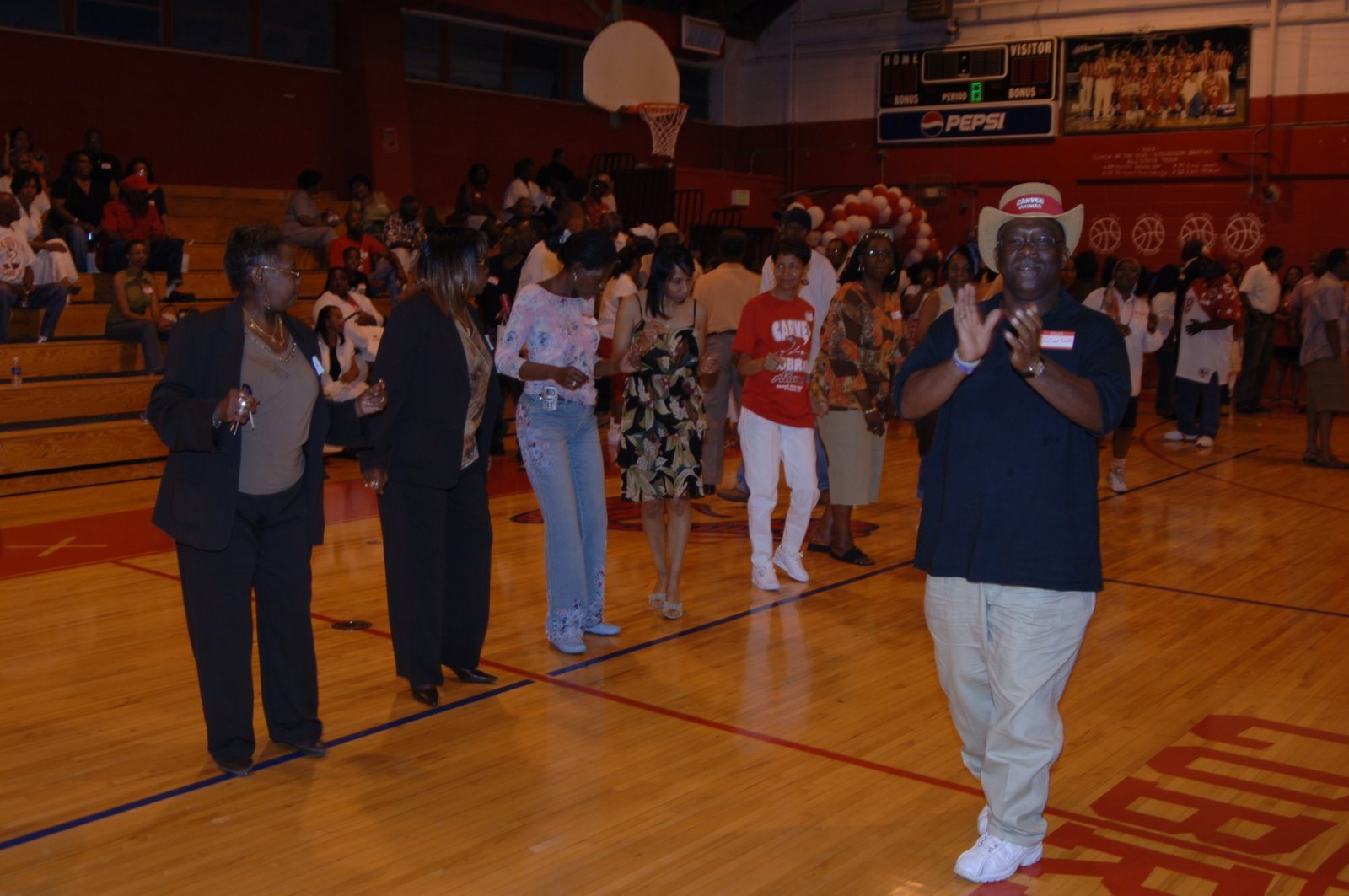 Alumni dancing at school gymnasium event