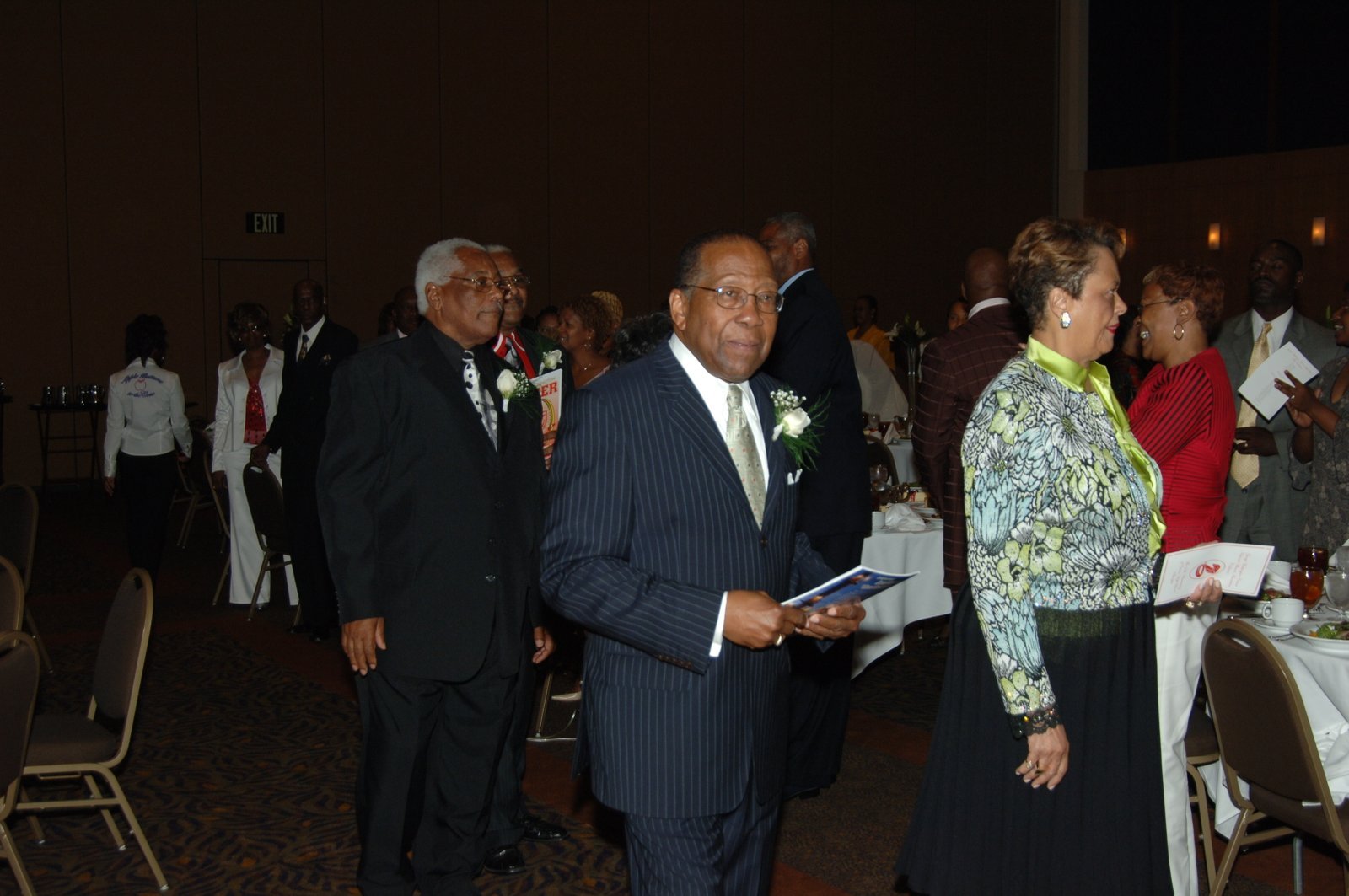 Group of alumni in formal attire at banquet