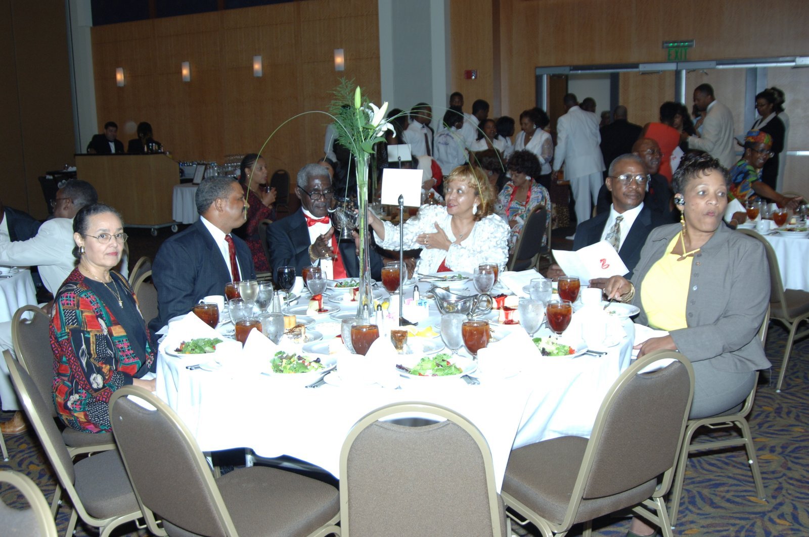 Alumni at formal dinner event with flowers and decorations