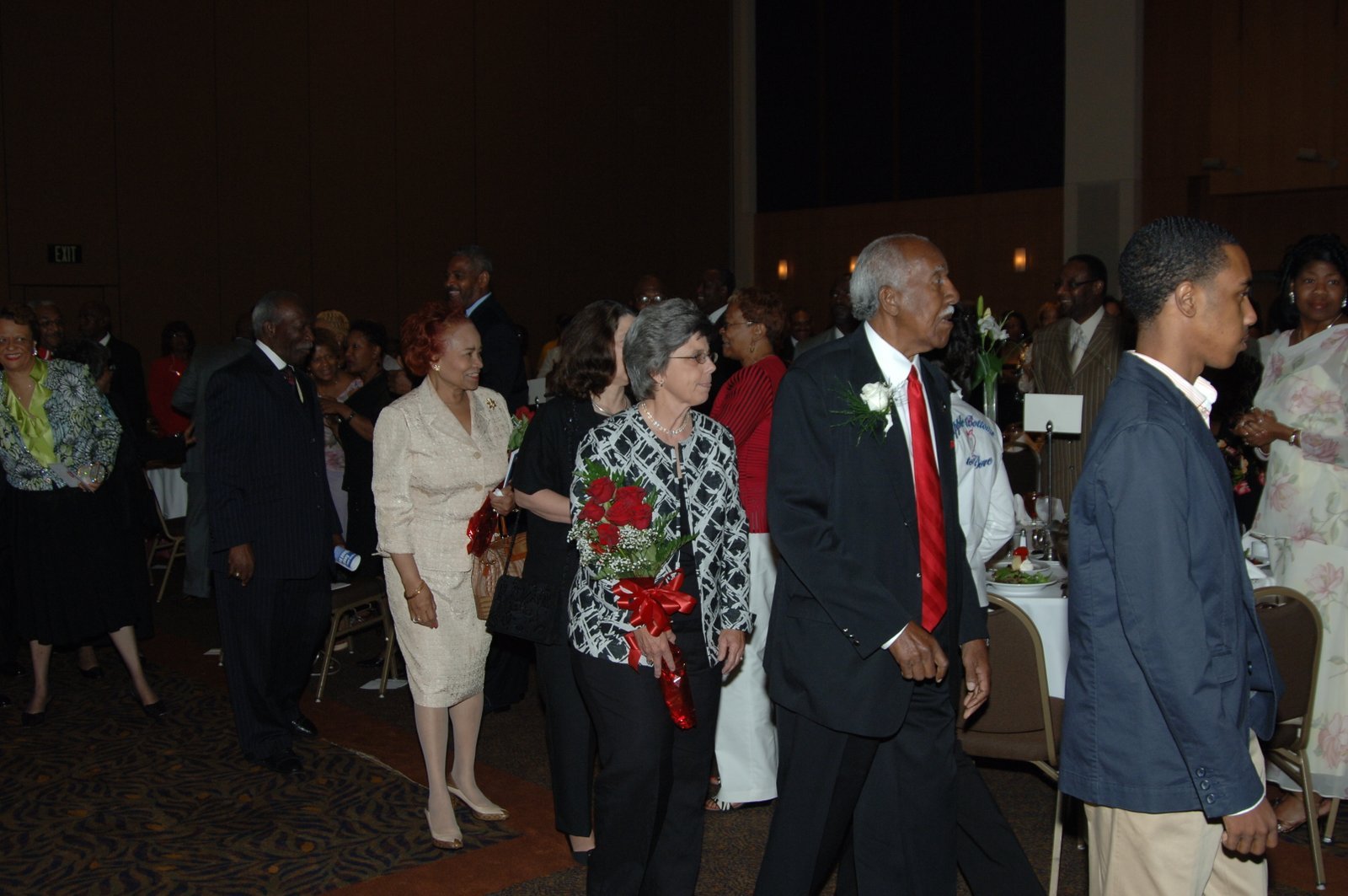 Alumni at school event with red and white theme