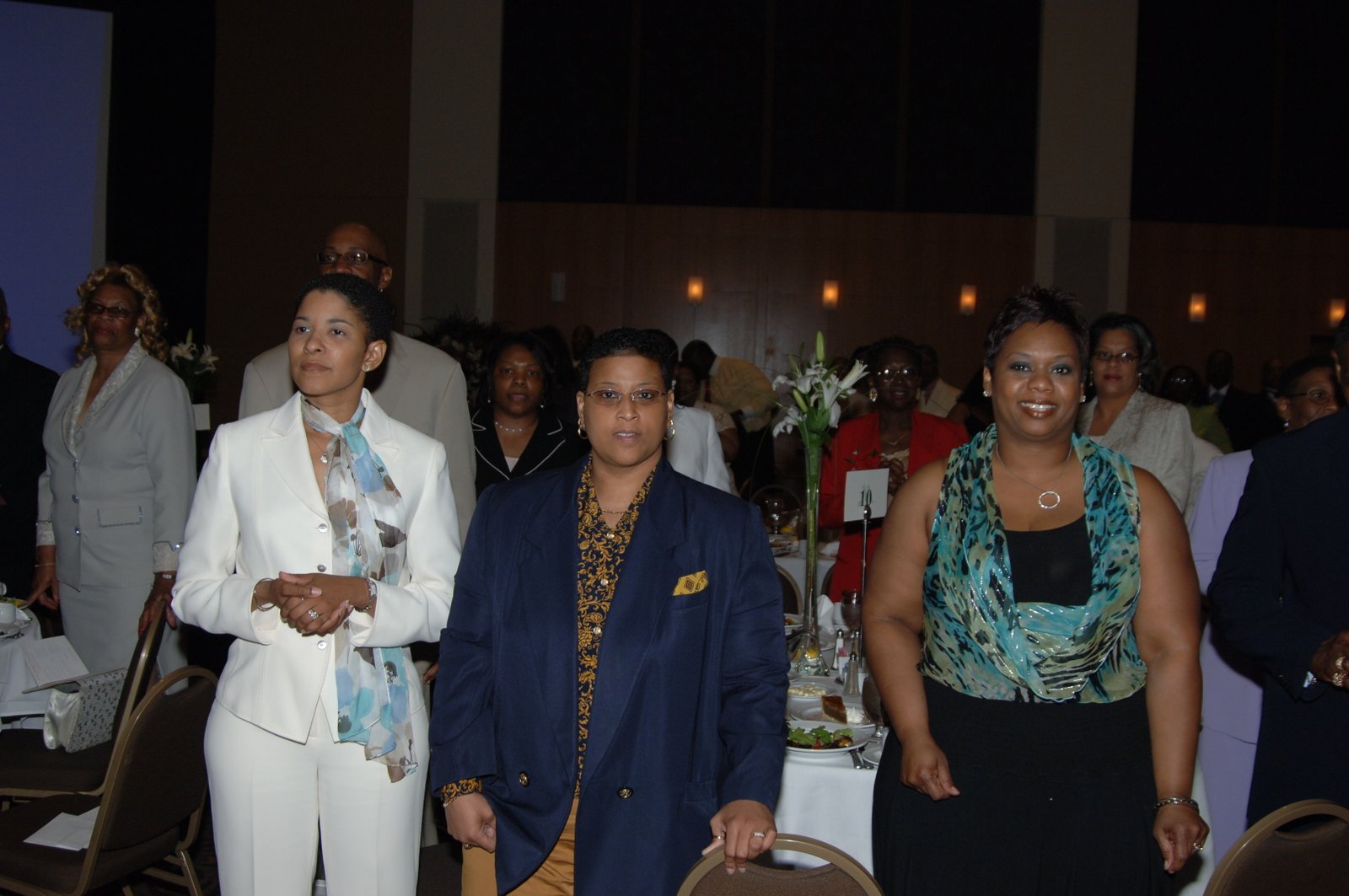 Alumni women in formal attire at banquet event