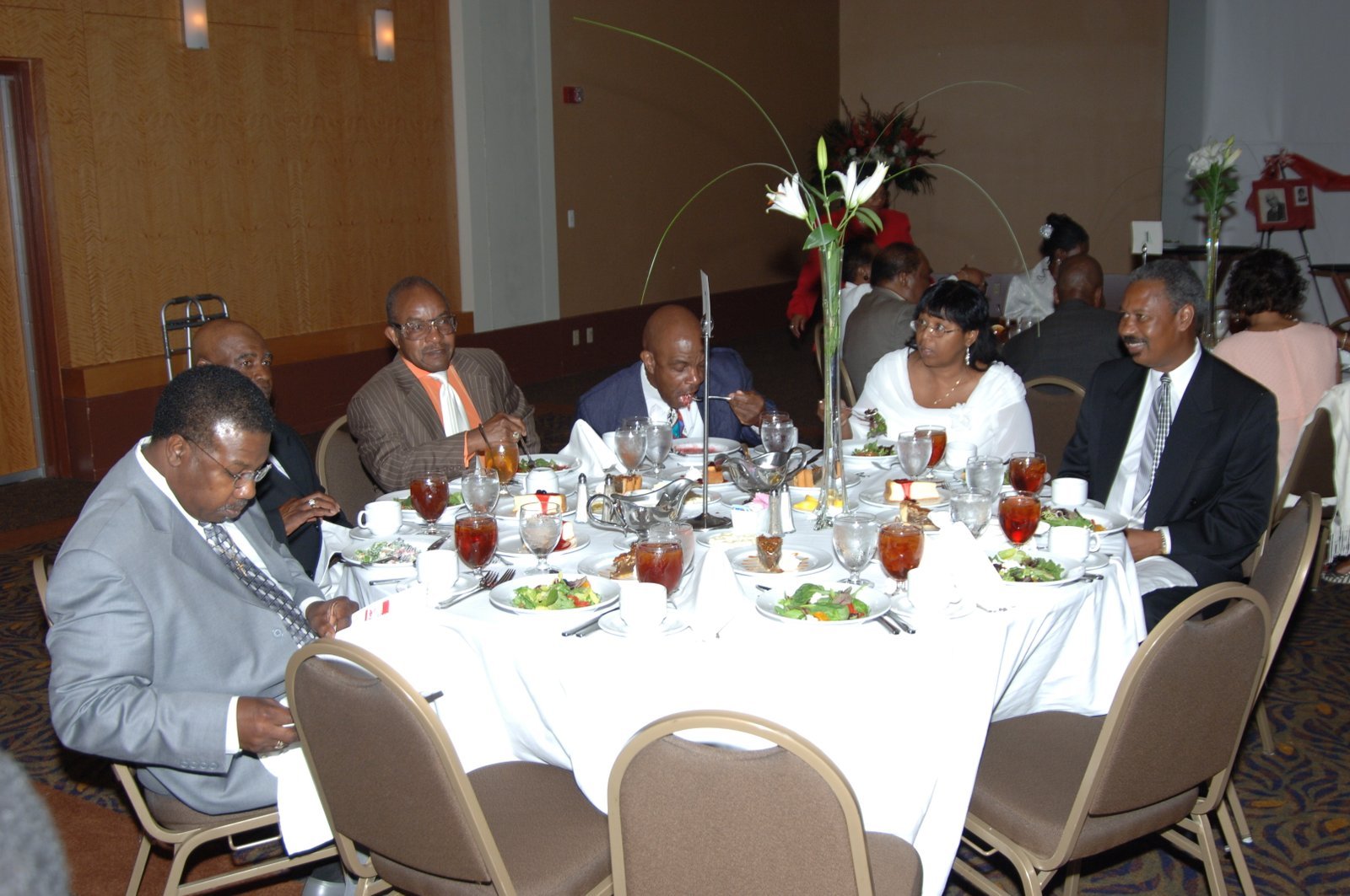 Alumni at formal event with elegant decor and flowers