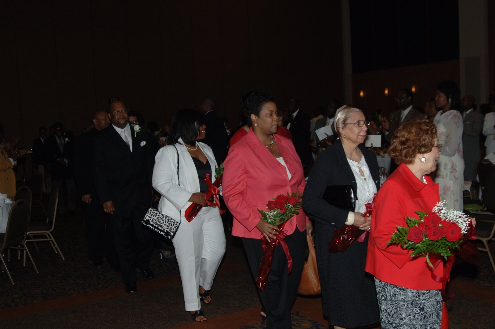 Alumni group at formal gala with flowers