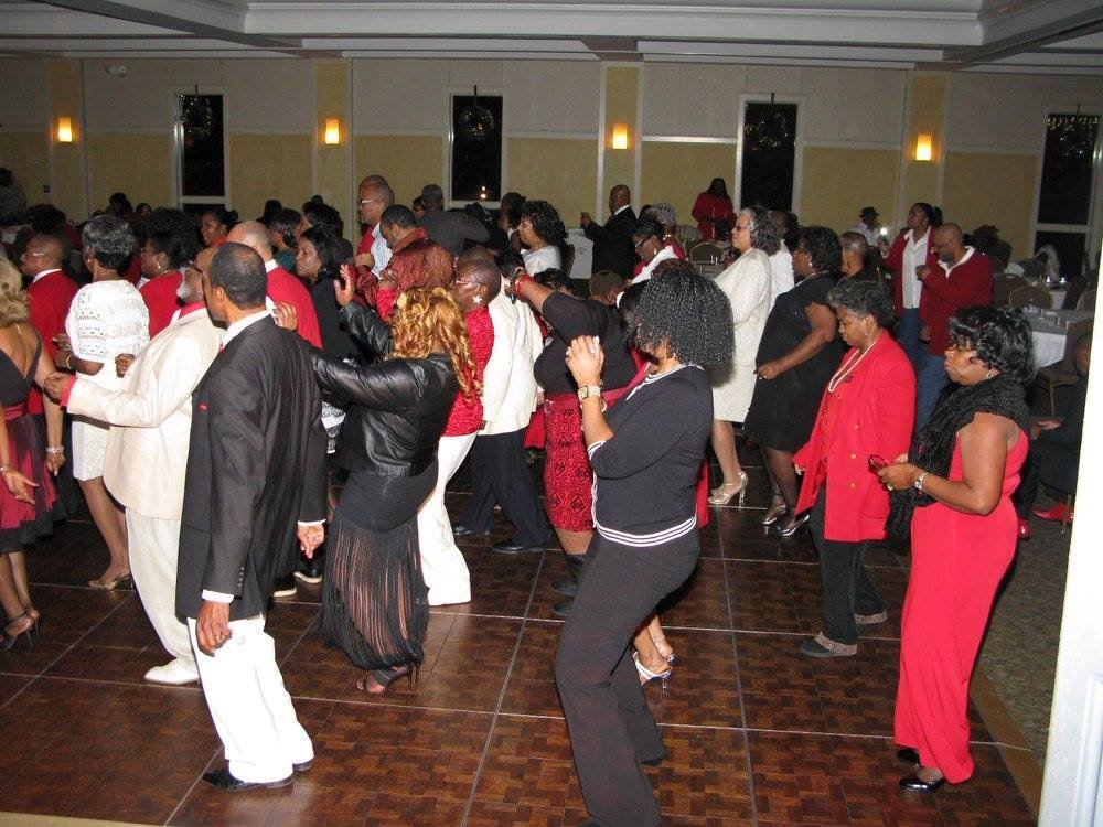 Alumni dancing and celebrating joyfully together at an event