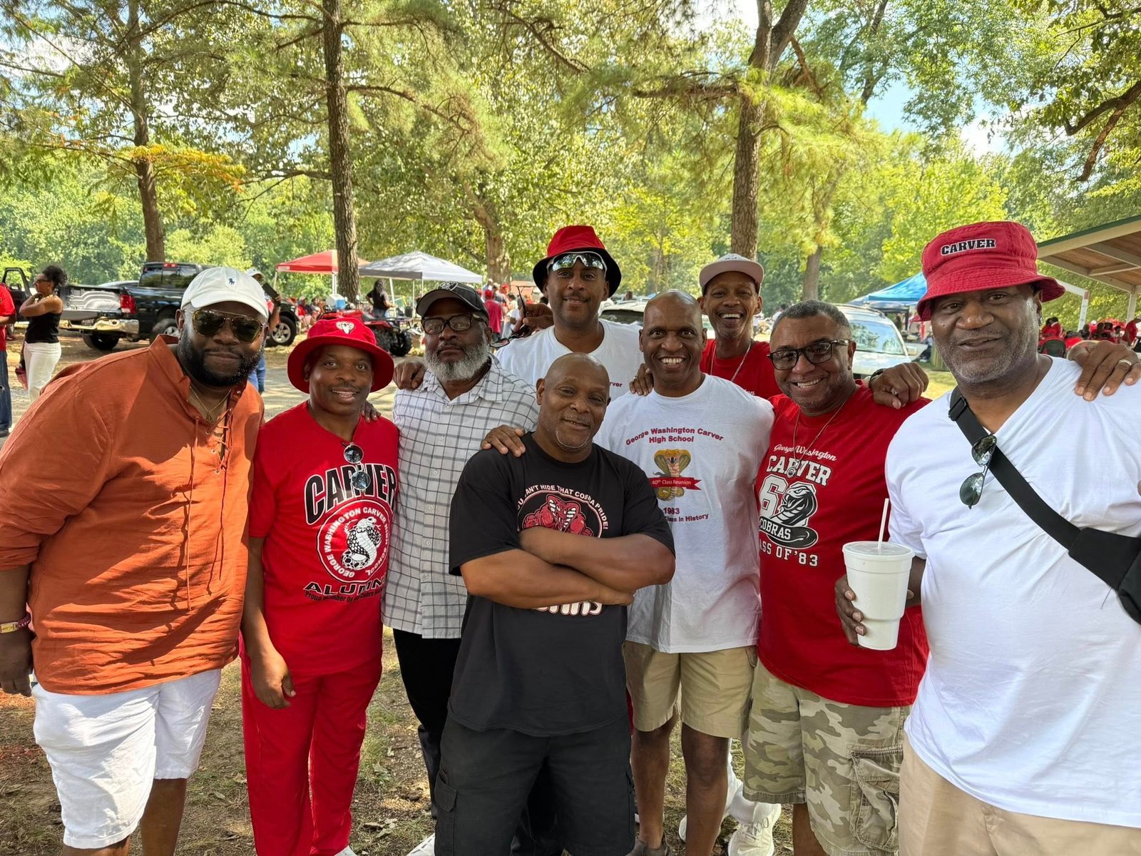 Alumni group at outdoor reunion event with tents