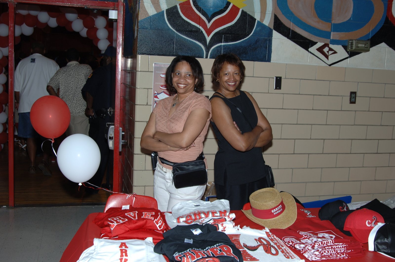 Alumni women at school merchandise table
